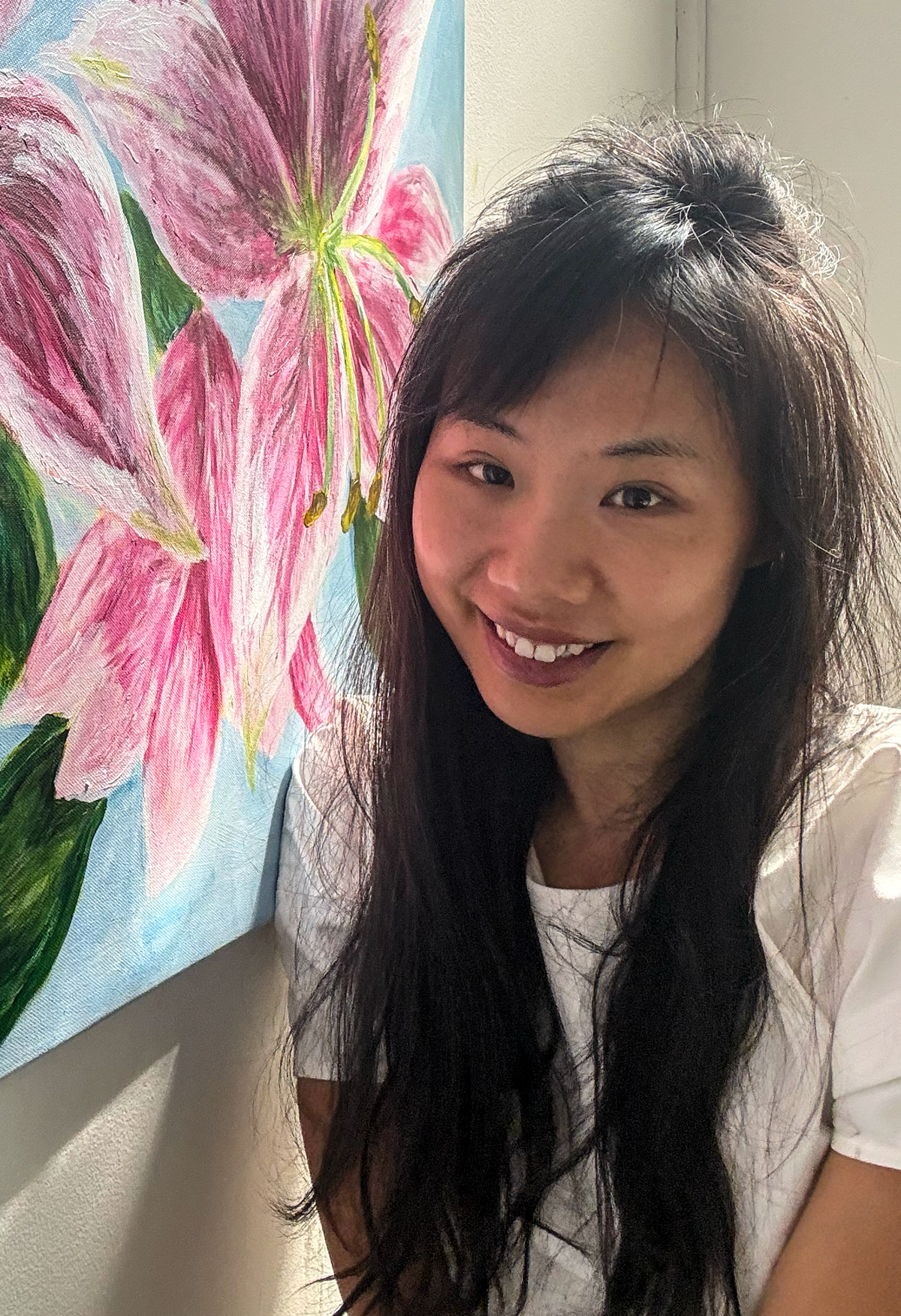 Jing with her paintings at the Between States exhibition in Rome
